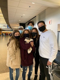 a group of people wearing face masks at an airport