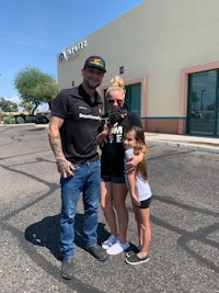 a man and a woman posing for a picture in front of a store
