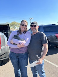 a man and woman standing in a parking lot